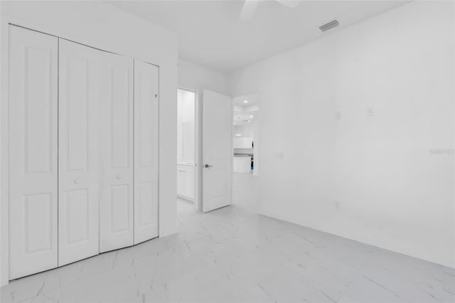 3924 NW 38th St, Cape Coral, FL 33993 - unfurnished bedroom featuring light marble finish flooring, a closet, and a ceiling fan