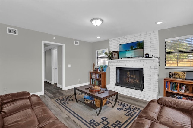 living room featuring hardwood / wood-style flooring and a fireplace