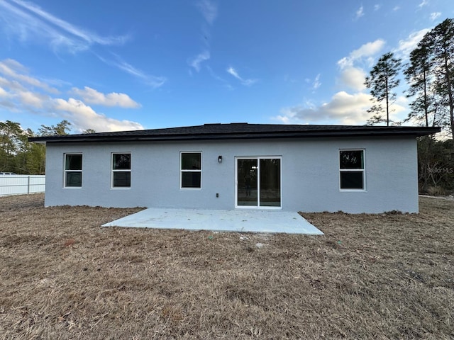 back of house featuring a patio, a yard, fence, and stucco siding