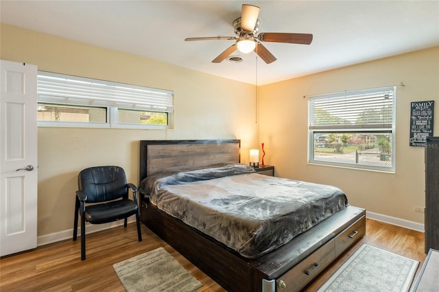 bedroom with visible vents, multiple windows, and light wood-style flooring