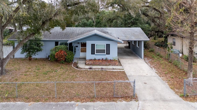 view of front of house with driveway, a fenced front yard, an attached carport, and roof with shingles