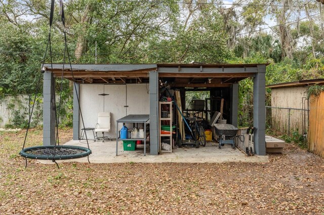 view of outbuilding with fence and an outbuilding