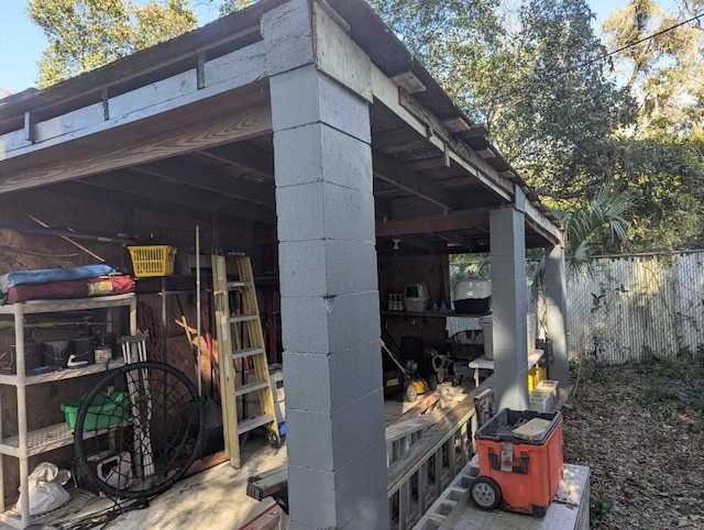 view of outbuilding featuring an outdoor structure and fence