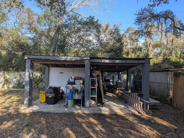 view of outdoor structure featuring an outbuilding and fence