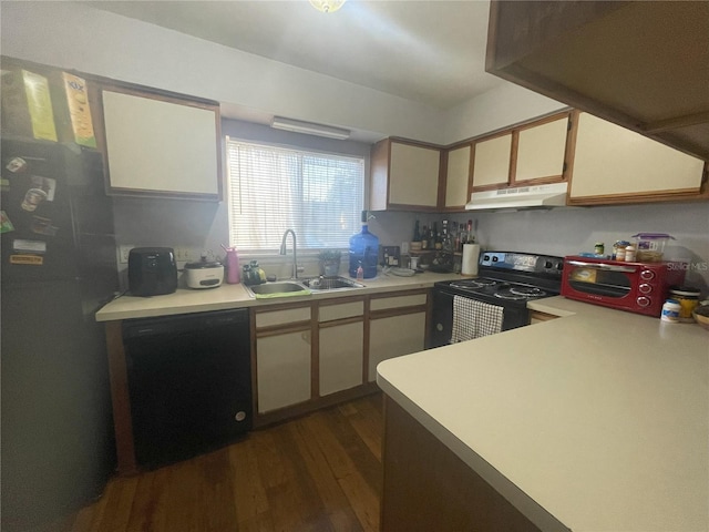 kitchen featuring black appliances, light countertops, under cabinet range hood, and a sink