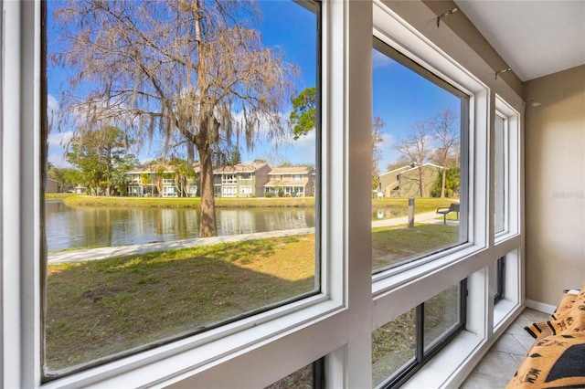 unfurnished sunroom with a water view