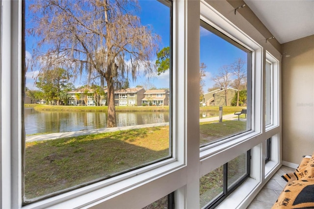 unfurnished sunroom with a water view