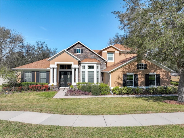 view of front of property with french doors and a front yard