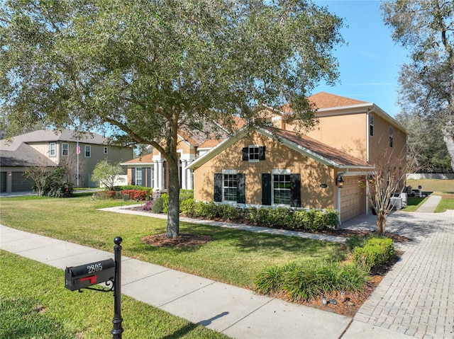 view of front of house with a front yard and a garage