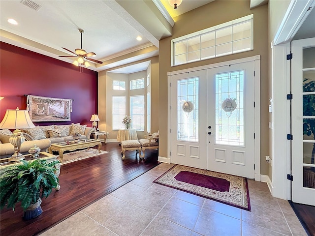 tiled entryway featuring french doors and ceiling fan