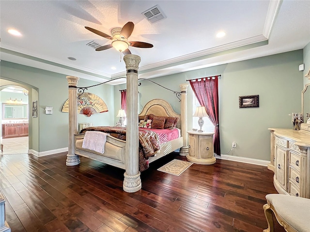 bedroom featuring ceiling fan, crown molding, dark hardwood / wood-style flooring, and a raised ceiling