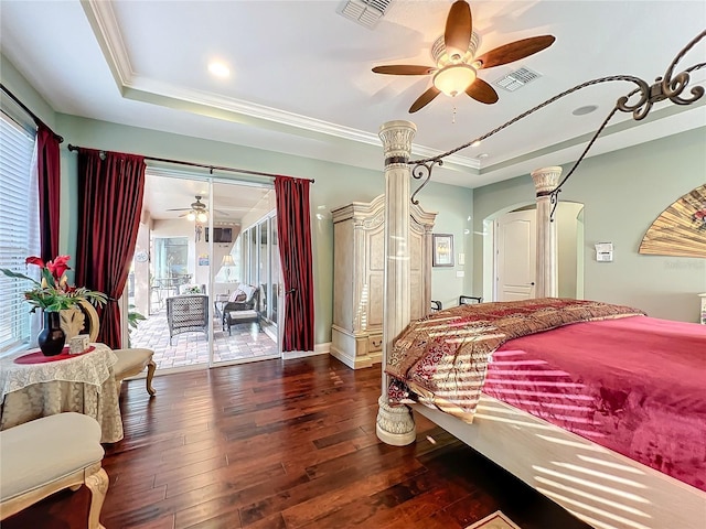 bedroom featuring dark wood-type flooring, ceiling fan, crown molding, a raised ceiling, and access to exterior