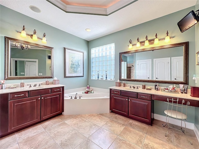 bathroom featuring a textured ceiling, a tub to relax in, and vanity