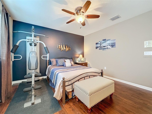 bedroom with ceiling fan and dark hardwood / wood-style floors