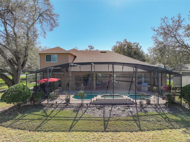 rear view of house with a patio, a swimming pool with hot tub, and glass enclosure