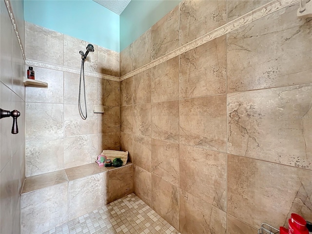 bathroom with a tile shower