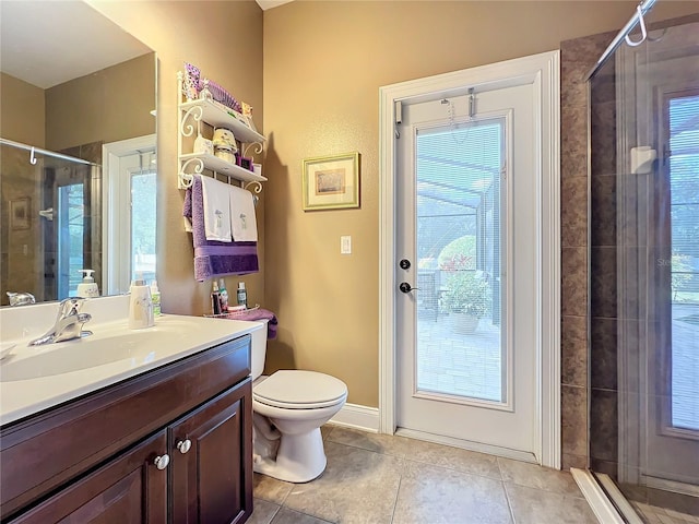 bathroom with toilet, a shower with door, tile patterned flooring, and vanity