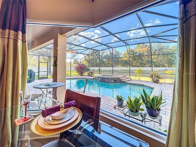 view of swimming pool featuring an in ground hot tub, a lanai, and a patio area