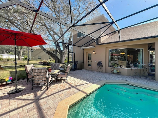 view of swimming pool featuring a patio and a lanai