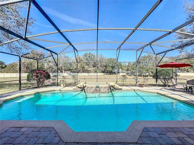 view of swimming pool featuring an in ground hot tub, a lanai, and a patio area