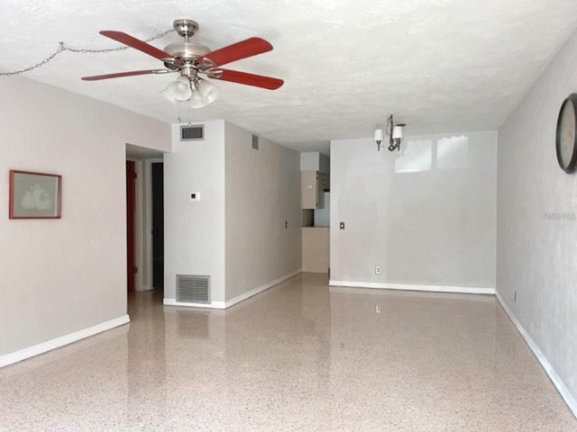 unfurnished room with a chandelier and a textured ceiling