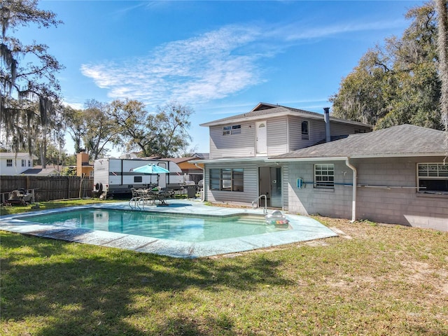 view of pool with a fenced in pool, fence, a patio, and a yard