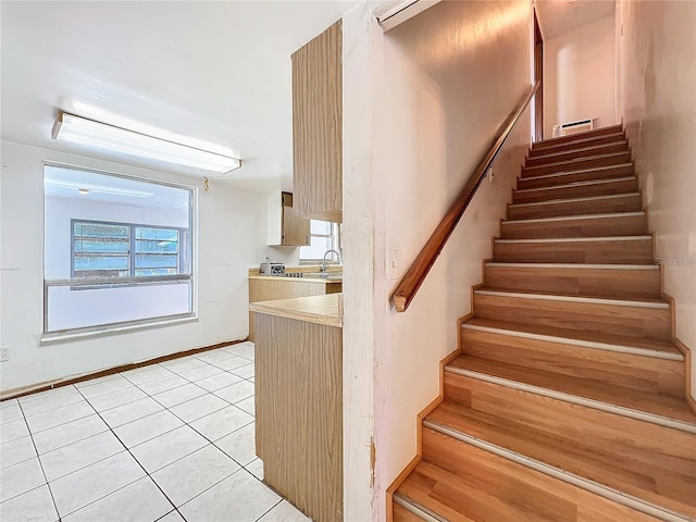 stairway with tile patterned flooring