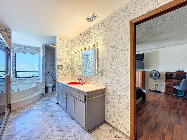 full bathroom with visible vents, a textured ceiling, toilet, and wallpapered walls