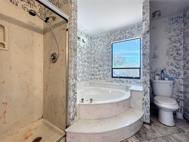 full bathroom featuring a bath, a shower stall, toilet, and wallpapered walls