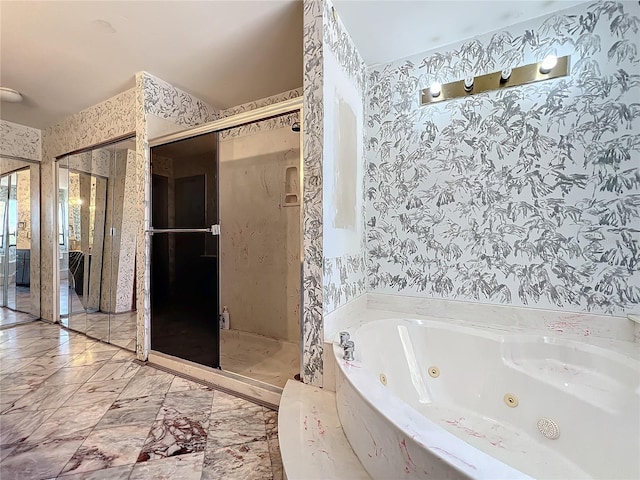 full bath featuring a stall shower, a tub with jets, and wallpapered walls