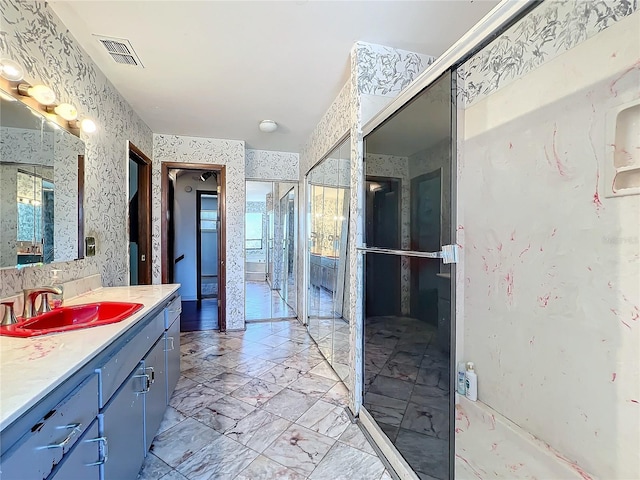 full bath with vanity, visible vents, marble finish floor, a shower stall, and wallpapered walls