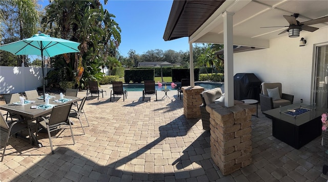 view of patio / terrace featuring a fire pit, a ceiling fan, a fenced in pool, area for grilling, and fence