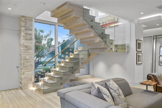staircase with recessed lighting and wood finished floors