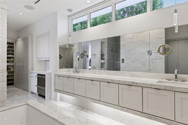 full bathroom featuring a sink, a marble finish shower, marble finish floor, and recessed lighting