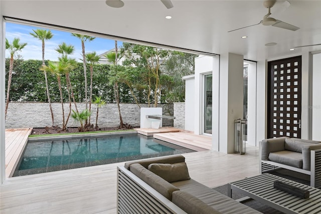 view of pool with a deck, a ceiling fan, fence, outdoor lounge area, and a fenced in pool