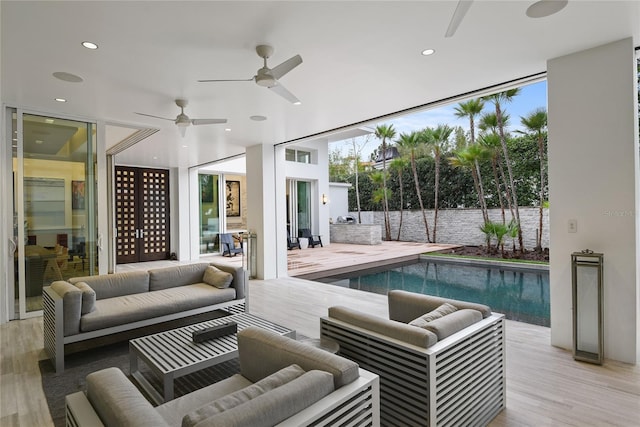 view of swimming pool featuring a fenced in pool, a deck, ceiling fan, and outdoor lounge area