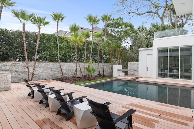 view of swimming pool featuring a fenced in pool and a deck