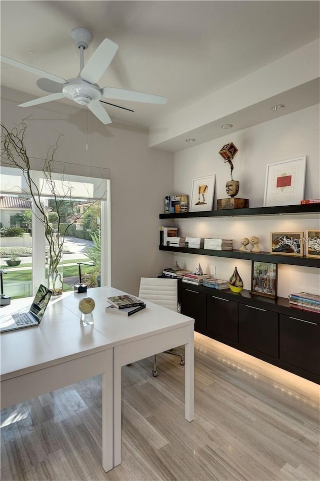 home office featuring light wood finished floors and ceiling fan
