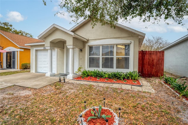 single story home with an attached garage, driveway, fence, and stucco siding