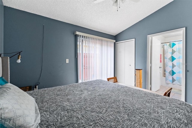 bedroom with a ceiling fan, a closet, vaulted ceiling, and a textured ceiling