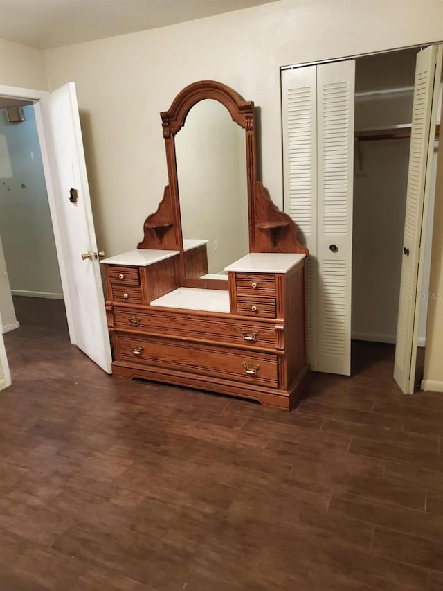 unfurnished bedroom featuring dark hardwood / wood-style floors and a closet