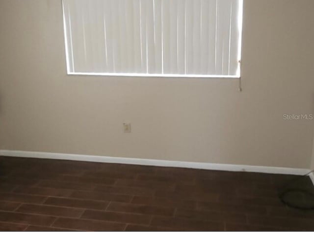 spare room featuring dark hardwood / wood-style floors