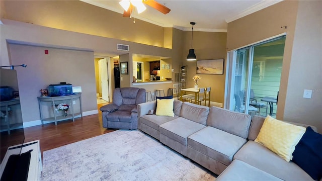 living room with high vaulted ceiling, ceiling fan, hardwood / wood-style flooring, and crown molding