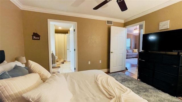 bedroom with ceiling fan, crown molding, and connected bathroom