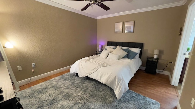 bedroom with ornamental molding, ceiling fan, and wood-type flooring