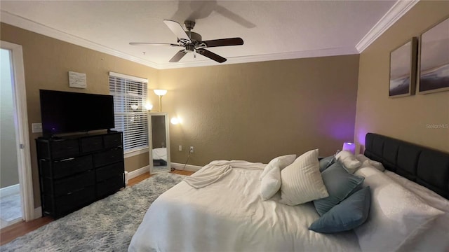 bedroom featuring ceiling fan, crown molding, and hardwood / wood-style floors