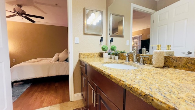 bathroom with vanity, tile patterned flooring, crown molding, and ceiling fan