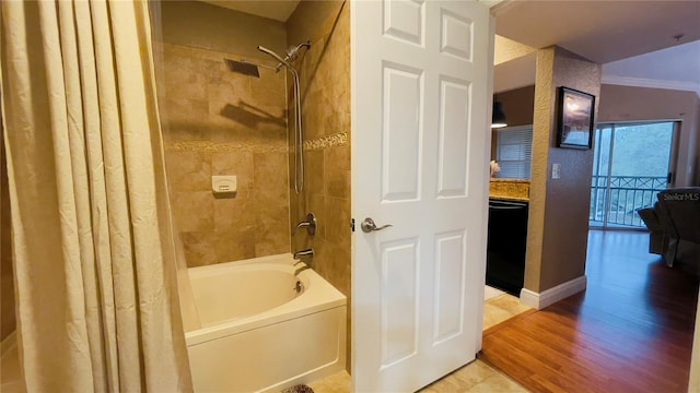 bathroom featuring hardwood / wood-style flooring and shower / tub combo with curtain