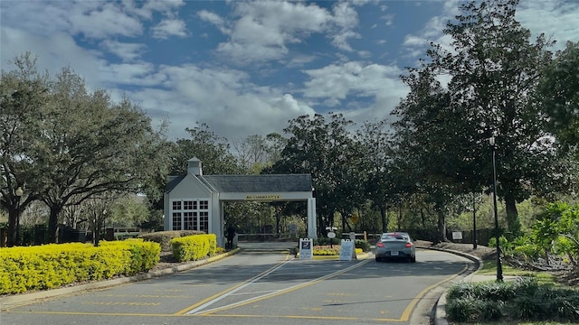 5017 City St Unit 1932, Orlando, FL 32839 - view of asphalt road featuring curbs and a gated entry