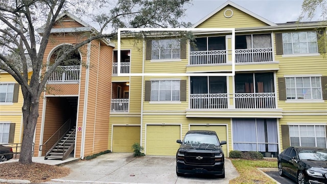 5017 City St Unit 1932, Orlando, FL 32839 - view of property featuring an attached garage, driveway, and stairs
